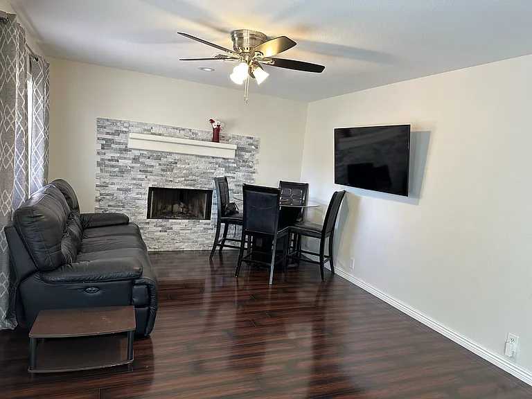 Living room featuring a beautifully decorated fireplace.