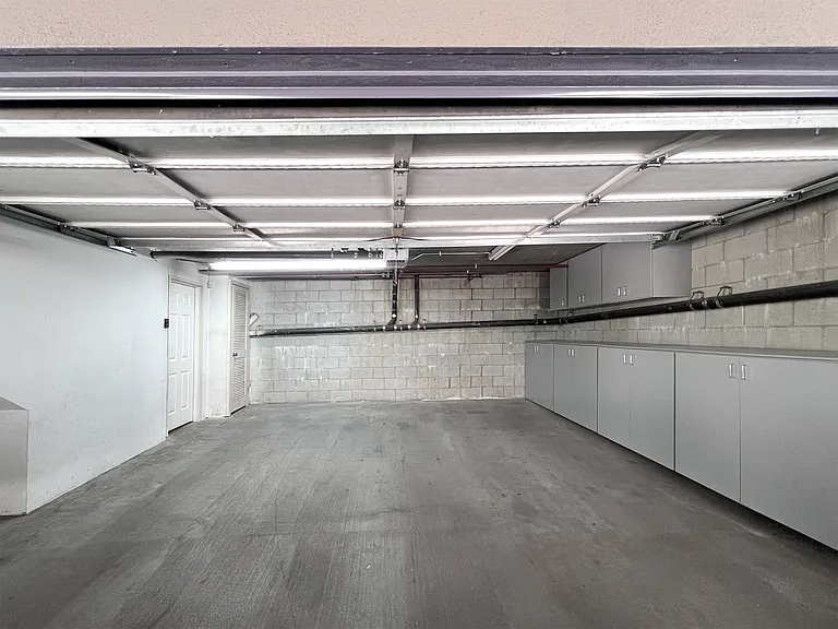 Spacious attached 2-car garage with private basement access, and secure indoor parking.
