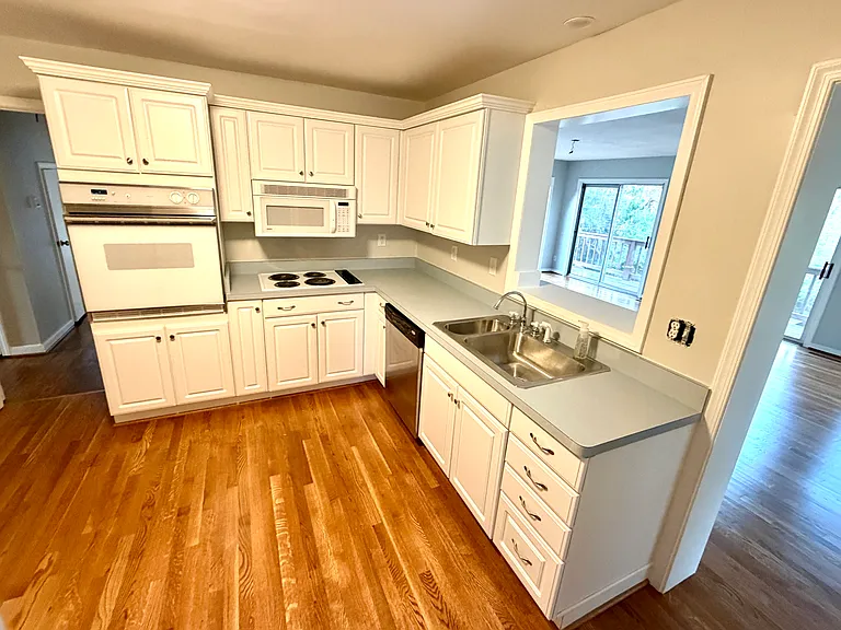 Updated kitchen with electric wall oven and cooktop. Stainless steel dishwasher and refrigerator.