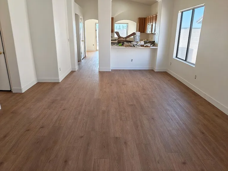 Main living room/dining room (before blinds & appliances were installed) with shotgun access to Arizona room, covered patio and pool. Black Fridge to be put back once work inside is completed. Room for 3 barstools and formal dining room table