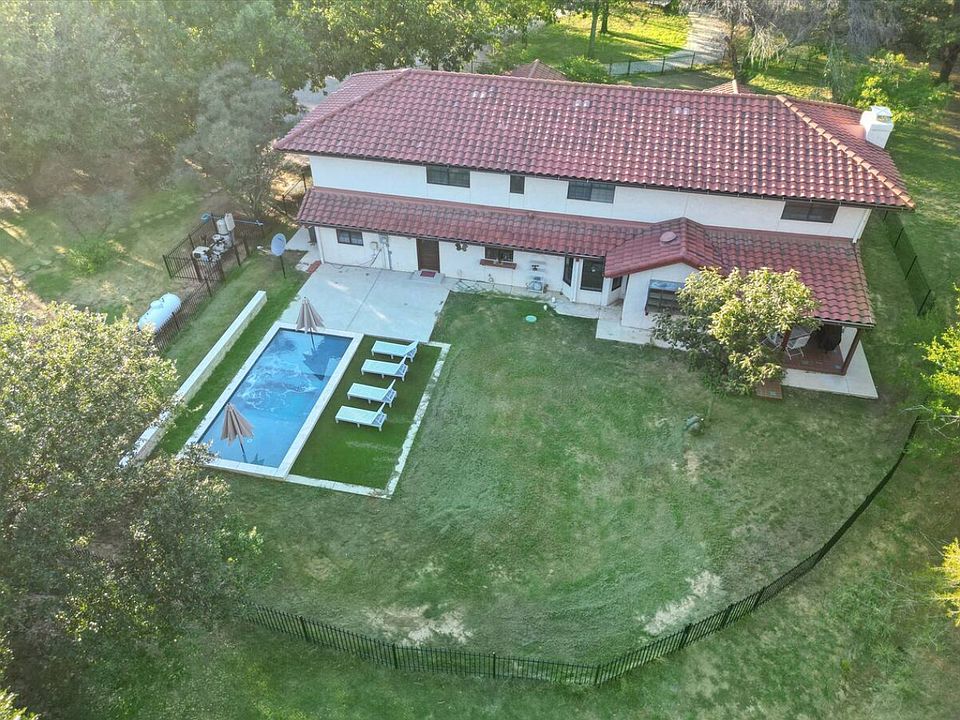 Go swimming in the pool with sun loungers and umbrellas as well as a beautiful view of the property.