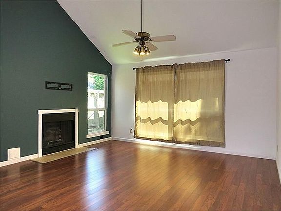 Living room features laminate flooring and a fireplace!
