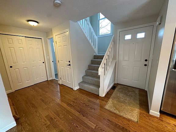 First floor closet, bathroom door, basement access, and stairs to upstairs bedrooms and bathroom.