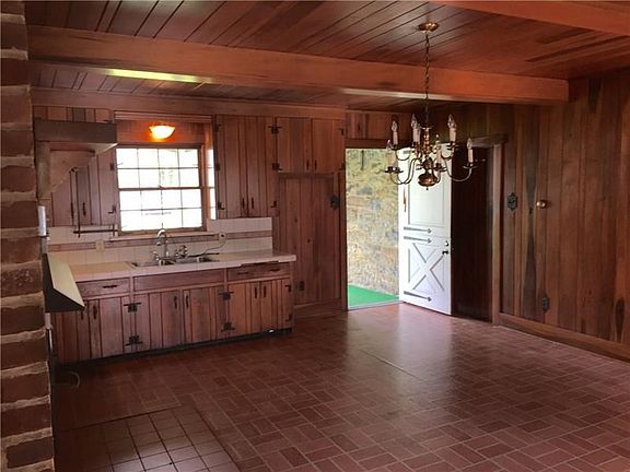 Giant 16x20 Kitchen/Dining Area with a back door onto the screened in porch.  Solid Cherry cabinets, walls and ceiling.