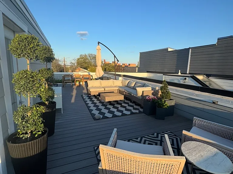 The 800 square foot private roof deck also features a dining area with seating for 4-6 people and a small green space area