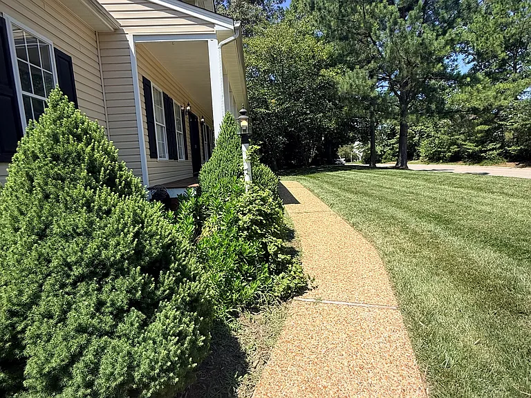 Aggregate sidewalk leading up to the beautiful front porch. Note- the garage is side entry