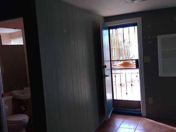 Saltillo tile, double lock screen and door. Bathroom with shower on left.