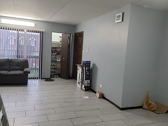 Living room, and balcony outside, coat closet