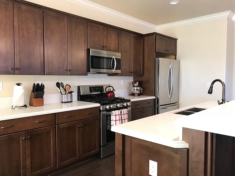 Stunning kitchen featuring quartz countertops, stainless steel appliances, and abundant cabinetry.