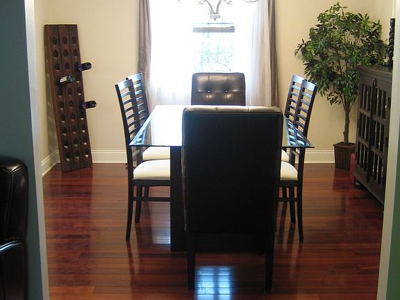 The dining room has lovely crown molding and hardwod flooring.