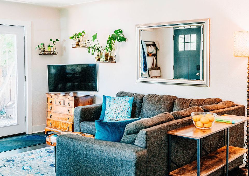 Living room with smart TV, space to relax, and bright French doors leading outdoors to the backyard.