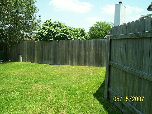 Other side of back yard, includes 2 storage sheds