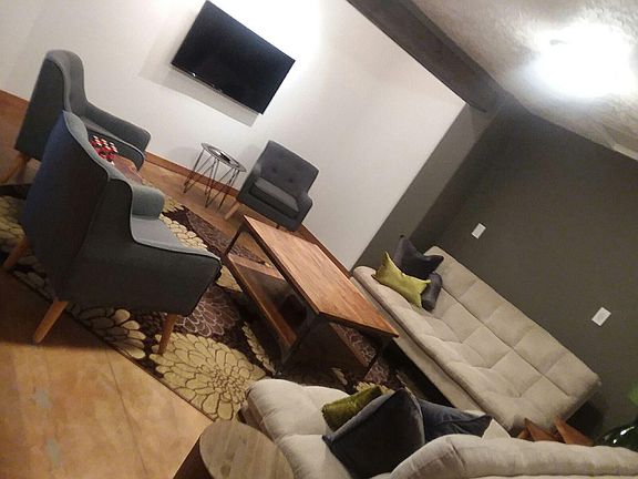 Living room is stylish and seats up to 8. Great for entertaining!