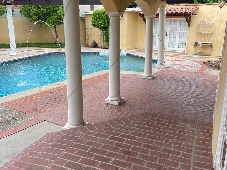 Covered area outside living room facing the pool area.