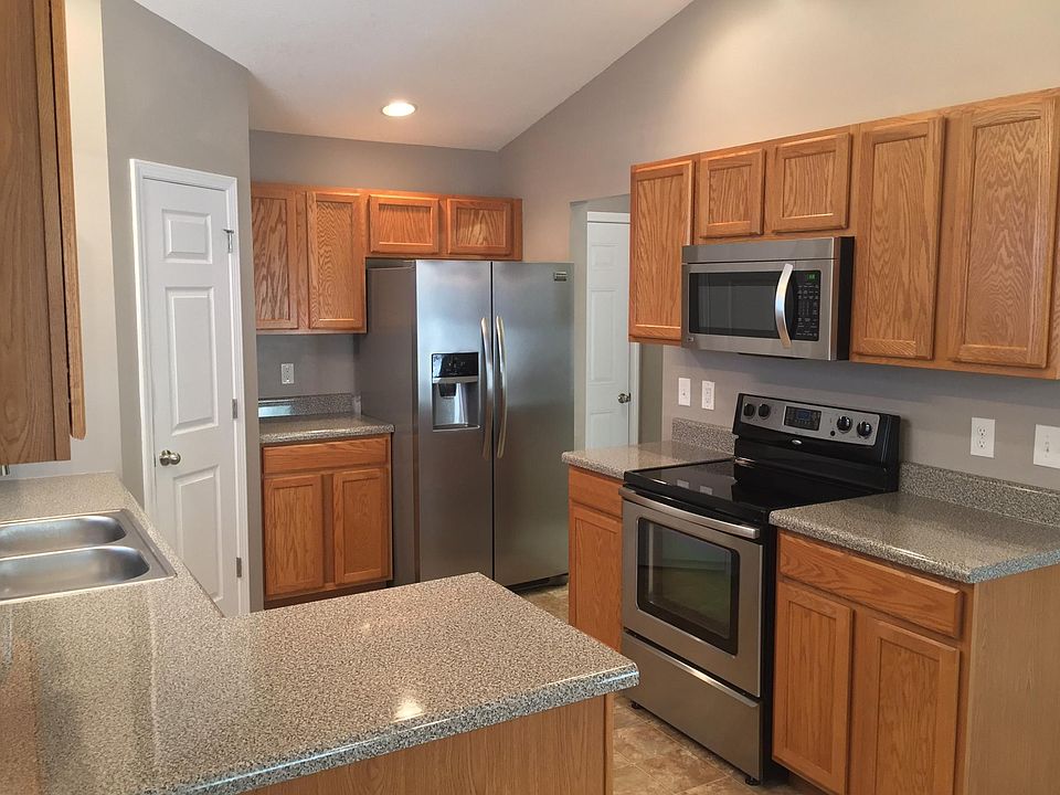 Kitchen has lots of counter space, recessed lighting & a pantry