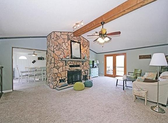 Great room with woodburning fireplace. Back porch is through the double doors.