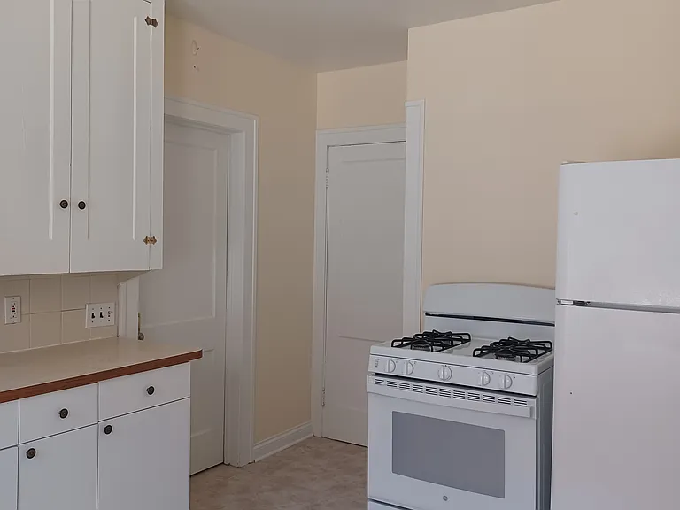 Kitchen view 3 - newer appliances and tile flooring.