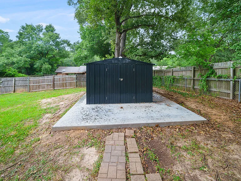 Backyard with new storage shed on a new cement pad