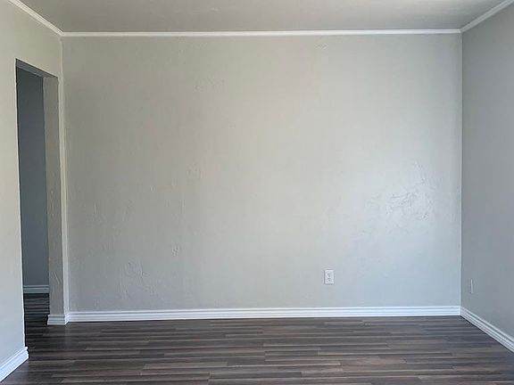 As you walk in front door, to your right is the living room. The doorway on the left goes to the hallway bath and two bedrooms.