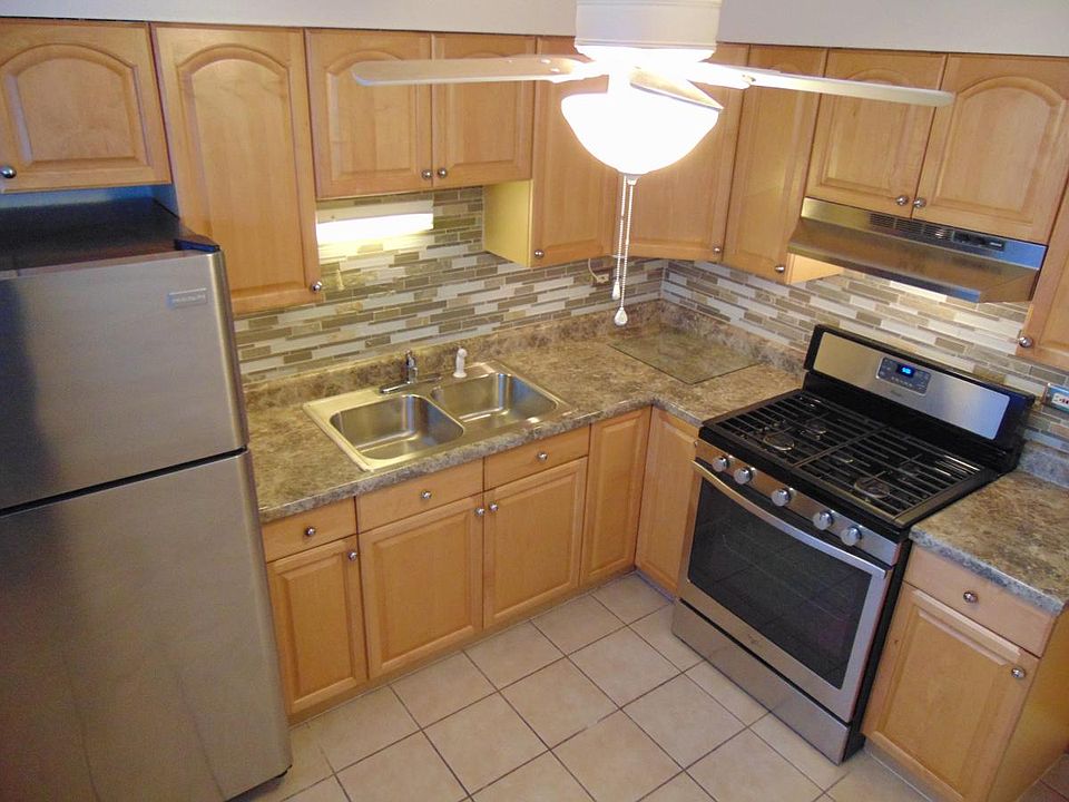 Kitchen with stainless steel appliances and the beautiful backspalsh.