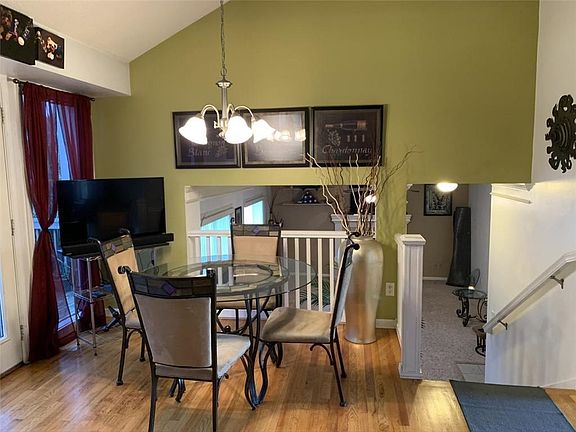 Wood floors continue from the kitchen into the dining area
