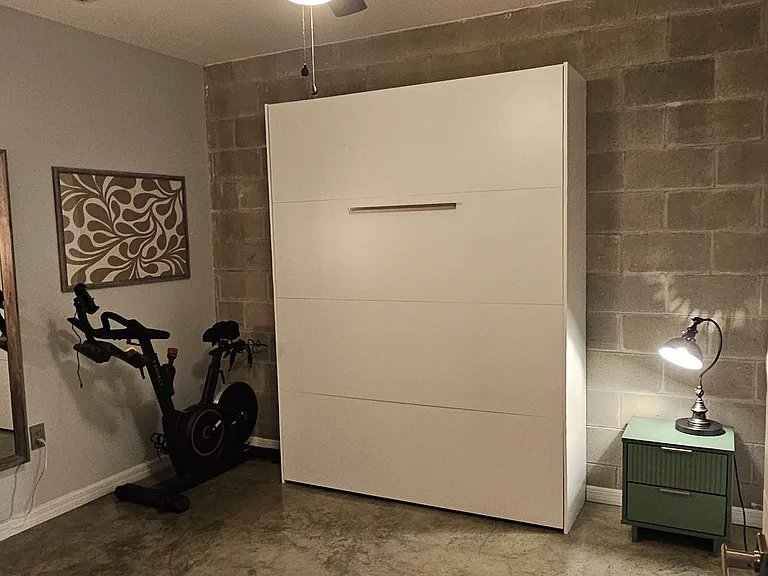 Second bedroom includes a murphy bed that pulls down into a queen bed. This room also includes an Echelon stationary bike.