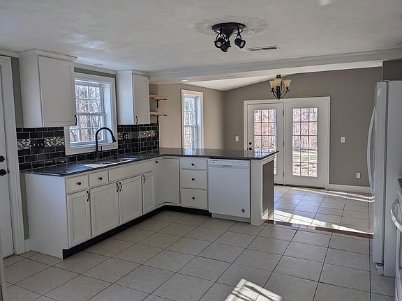 kitchen with large dining room and bar area