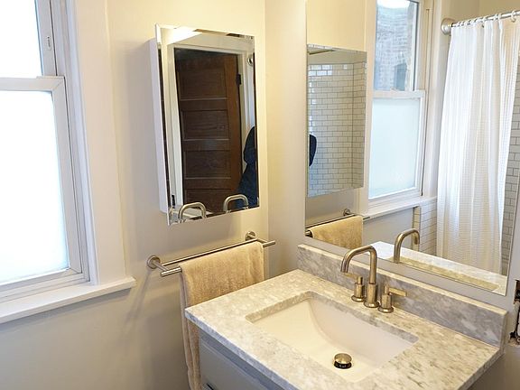 Updated marble bathroom with soaking tub