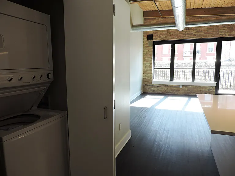 Angle from Front Door showing Laundry Closet and Living Room/Kitchen Island
