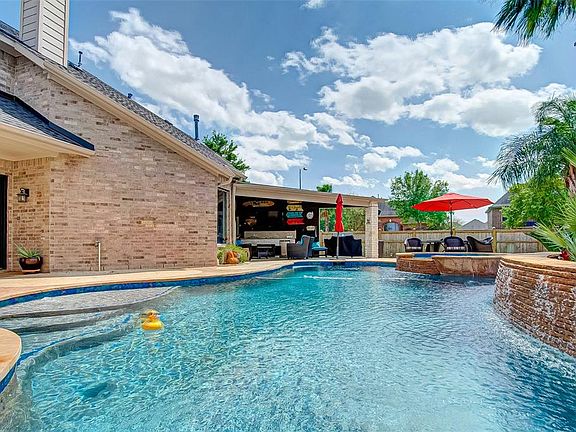 Look at this massive pool, hot tub and plenty of space for sunning! Or enjoy the great outdoors under the large, extended covered patio