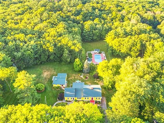 Aerial view of the home, cottage and beautiful pool area