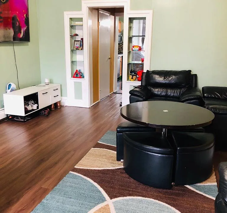 Living room which leads to Kitchen and on the left side the 1/2 bathroom door is visible.