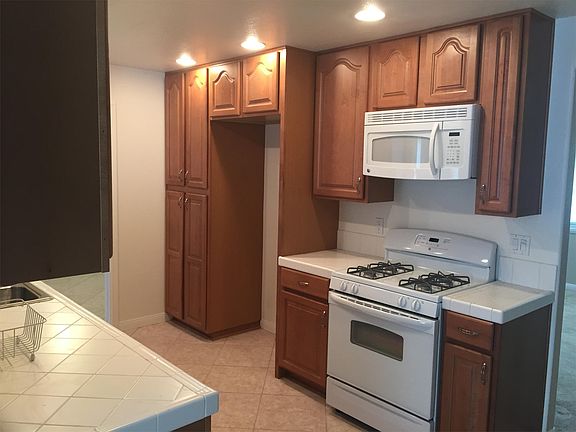 Kitchen with stove and microwave, large space for refridgerator