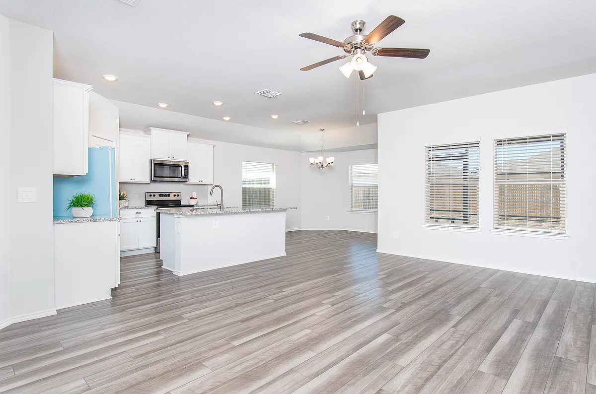 View from foyer hallway towards living room, kitchen, and dining area. - 2353 Aylesbury Dr