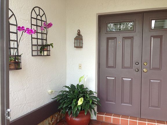 Screened-in front porch with double door entry