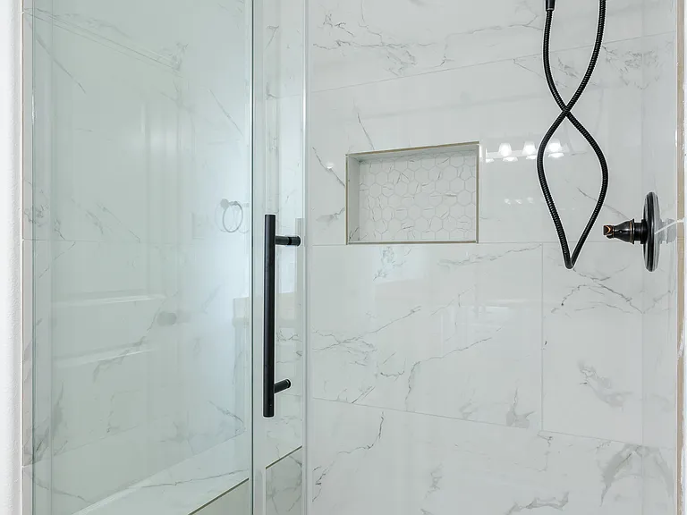 Luxury walk in shower room with slide door and seat