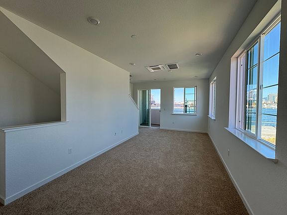 Large windows overlooking the waterfront and skyline.