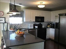 New flooring, quartz counters, lighting, microwave, sink. Spectacular!