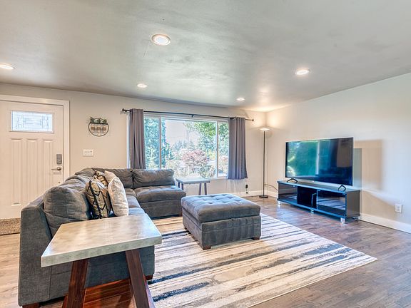 Comfortable and naturally bright living room with 65" HDTV