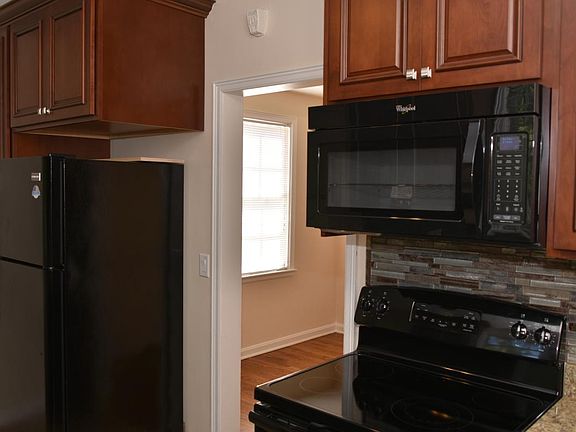 Microwave, smooth-top range/self-cleaning oven, fridge, dishwasher, vented exhaust fan, custom cherry cabinets