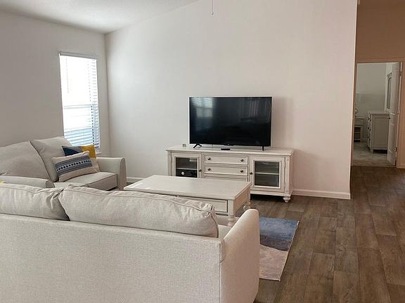 Living area has full couch plus love seat. 55" Roku TV. 

Seascape style wall art has been added since this photo.