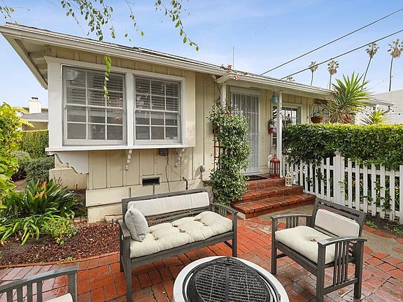 Front of unit with the private garden patio. *Outdoor furniture & firepit not included.