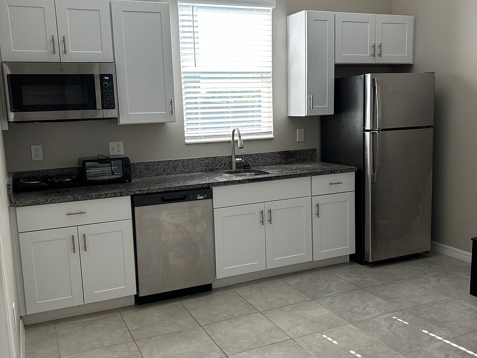 Kitchen with stainless steel appliances (convection microwave oven, dishwasher, refrigerator). Also, two burner stove-top and toaster oven.