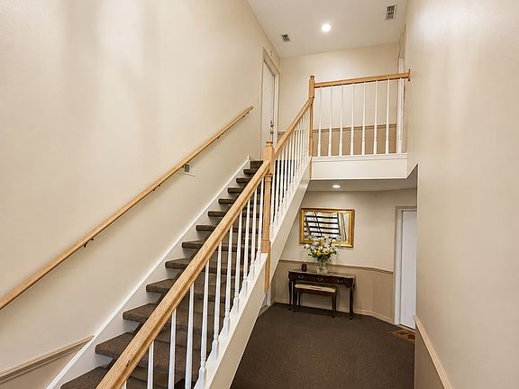 Private second-floor entrance with townhouse-style feel and soaring ceilings.