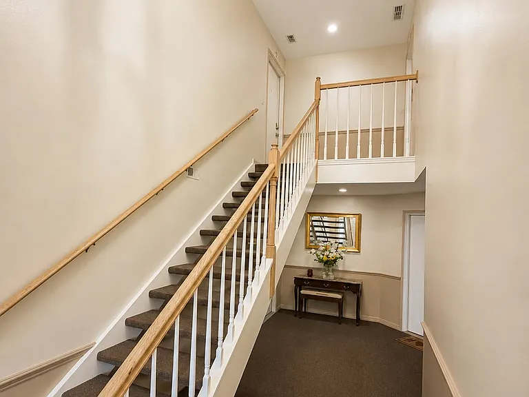 Private second-floor entrance with townhouse-style feel and soaring ceilings.