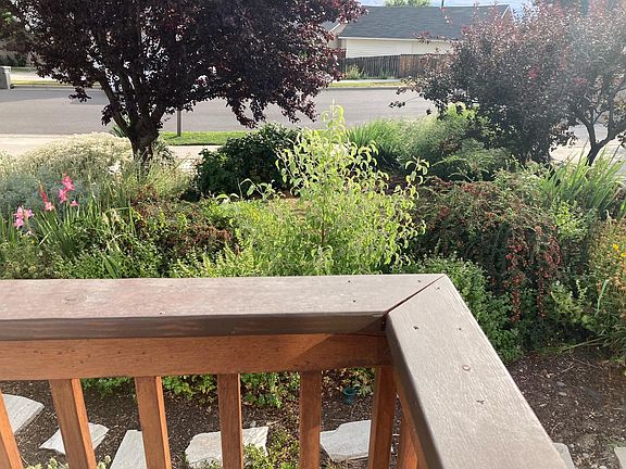 The front yard is fully irrigated, on a timer, and has a variety of trees, shrubs and flowers.