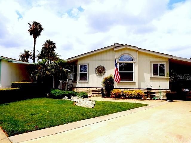 Front view.  One of the few units to have a front yard and extra long driveway!