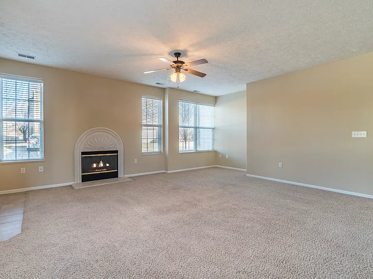 Bring your vision to life in this expansive living roomcomplete with a cozy fireplace, large windows for natural light, and plenty of space to spread out and settle in.