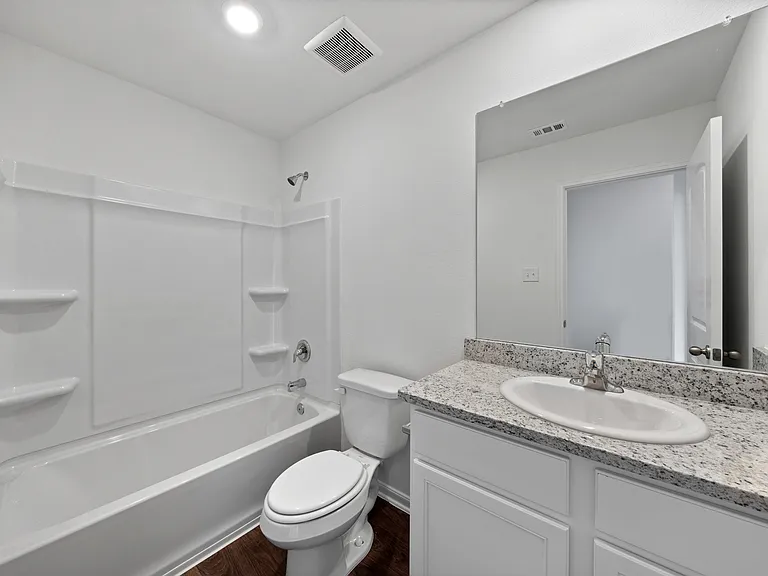The second bathroom with a shower/tub combination.