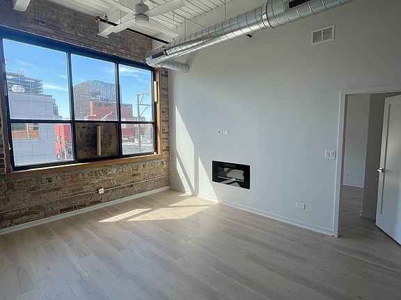 Living Room, this is an older picture. There is an operable window in place now. Room gets great light!
